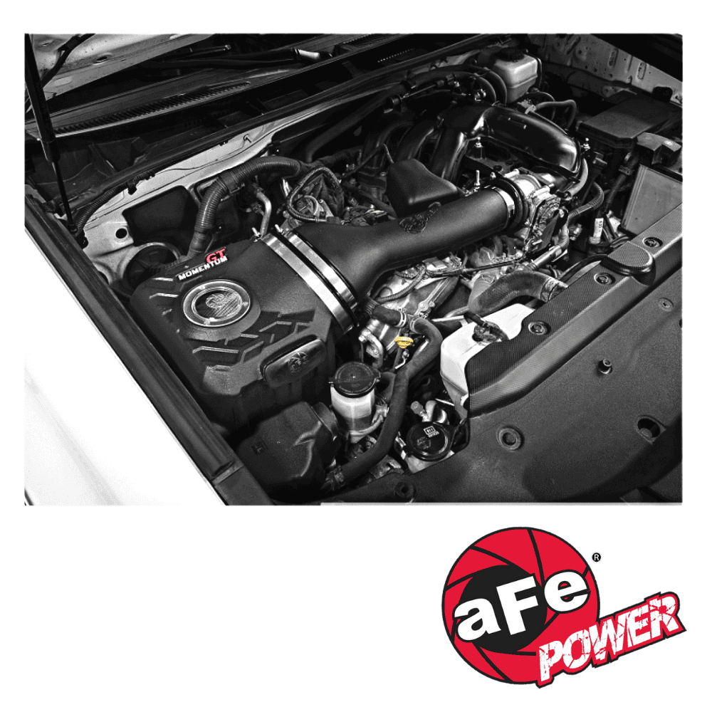 High-performance car engine with aftermarket modifications and a power logo.