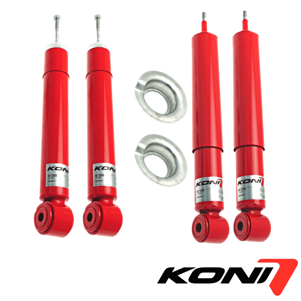 Red KONI shock absorbers with mounting hardware for vehicle suspension systems.