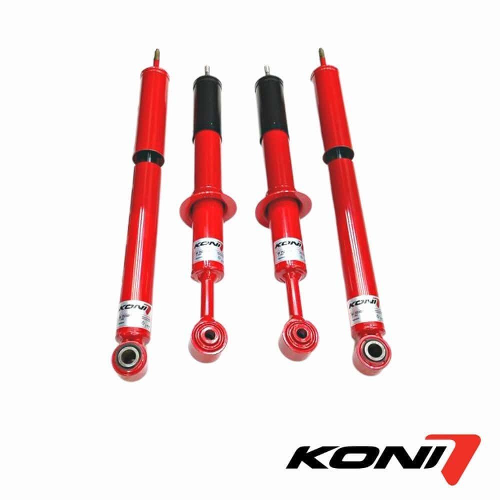 High-quality red and black shock absorbers for vehicle suspension systems by KONI. Durable automotiv.