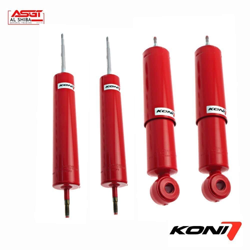 Red KONI shock absorbers for vehicle suspension systems, displayed in a row.