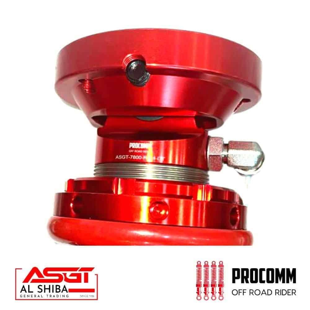 Red off-road rider shock absorber for vehicles, high durability and performance.