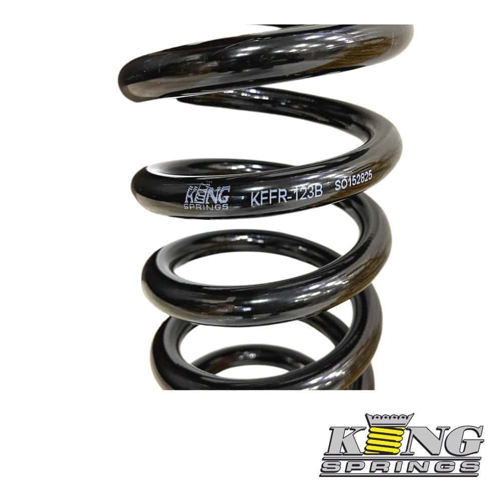 Heavy-duty black coil spring for industrial or automotive applications, showcasing durability and hi.