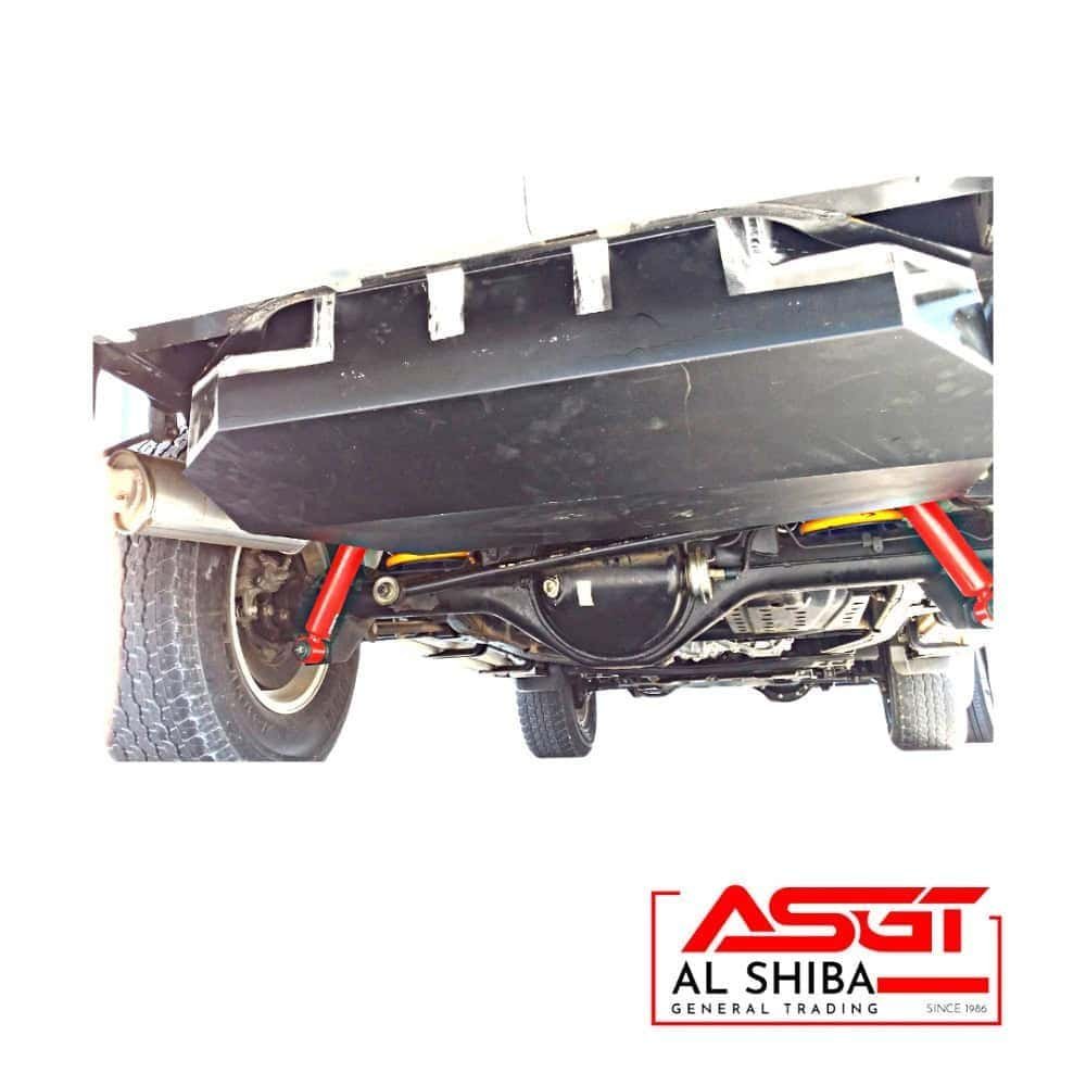 Heavy-duty undercarriage of a vehicle with red suspension components and tires, showcasing automotiv.