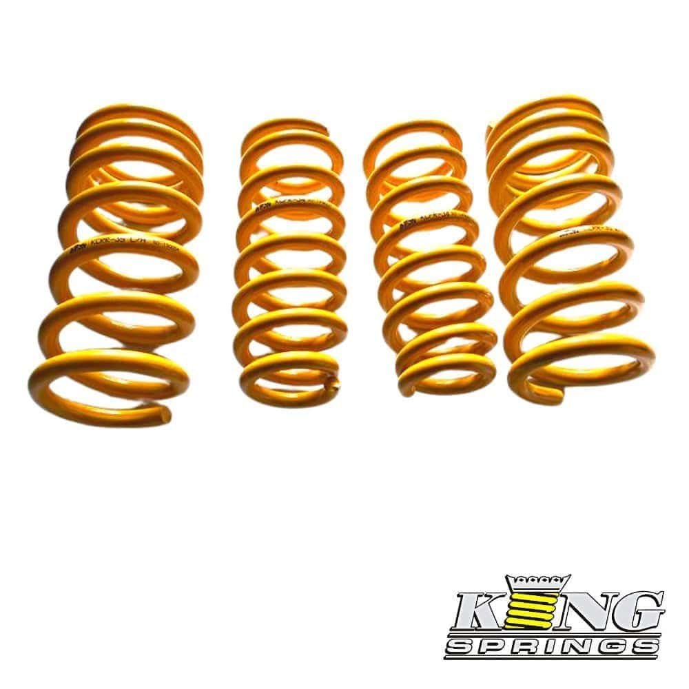 Yellow coil springs for automotive suspension, arranged in a row.
