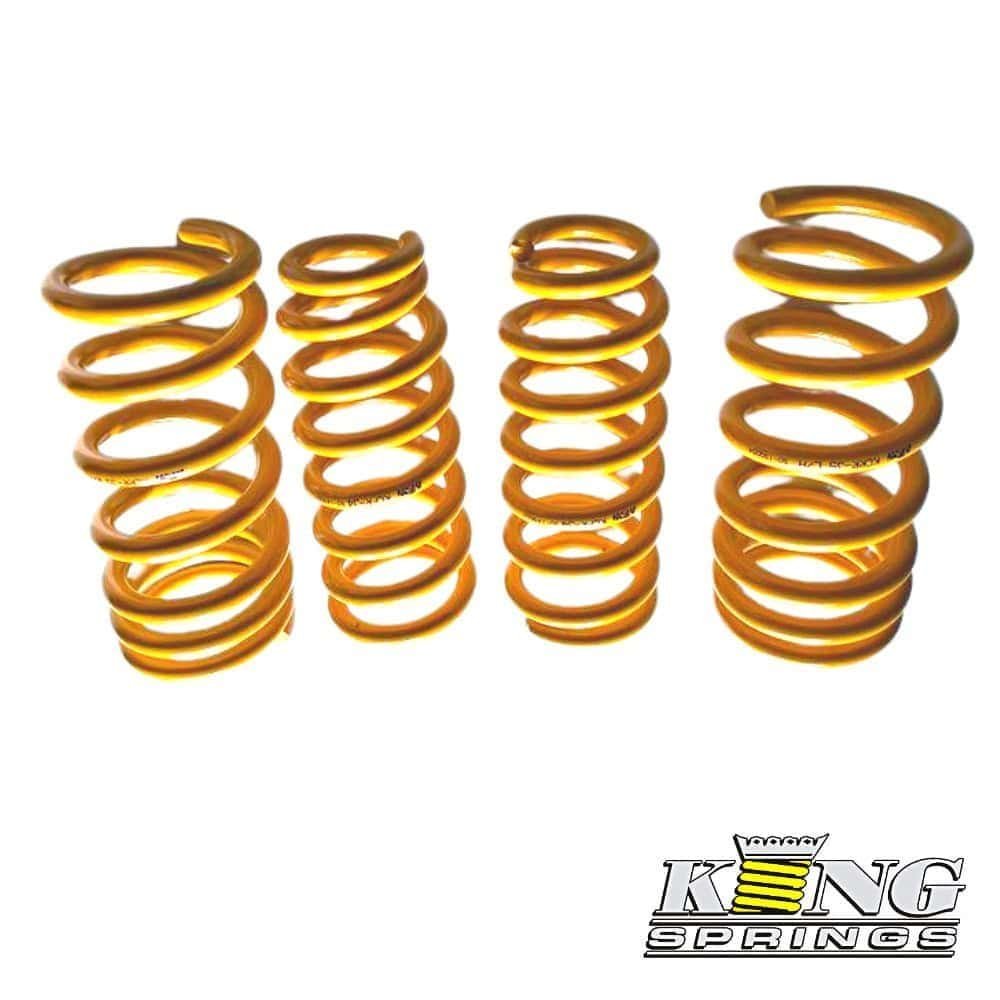 Gold coil springs for industrial or automotive use, arranged in a row.
