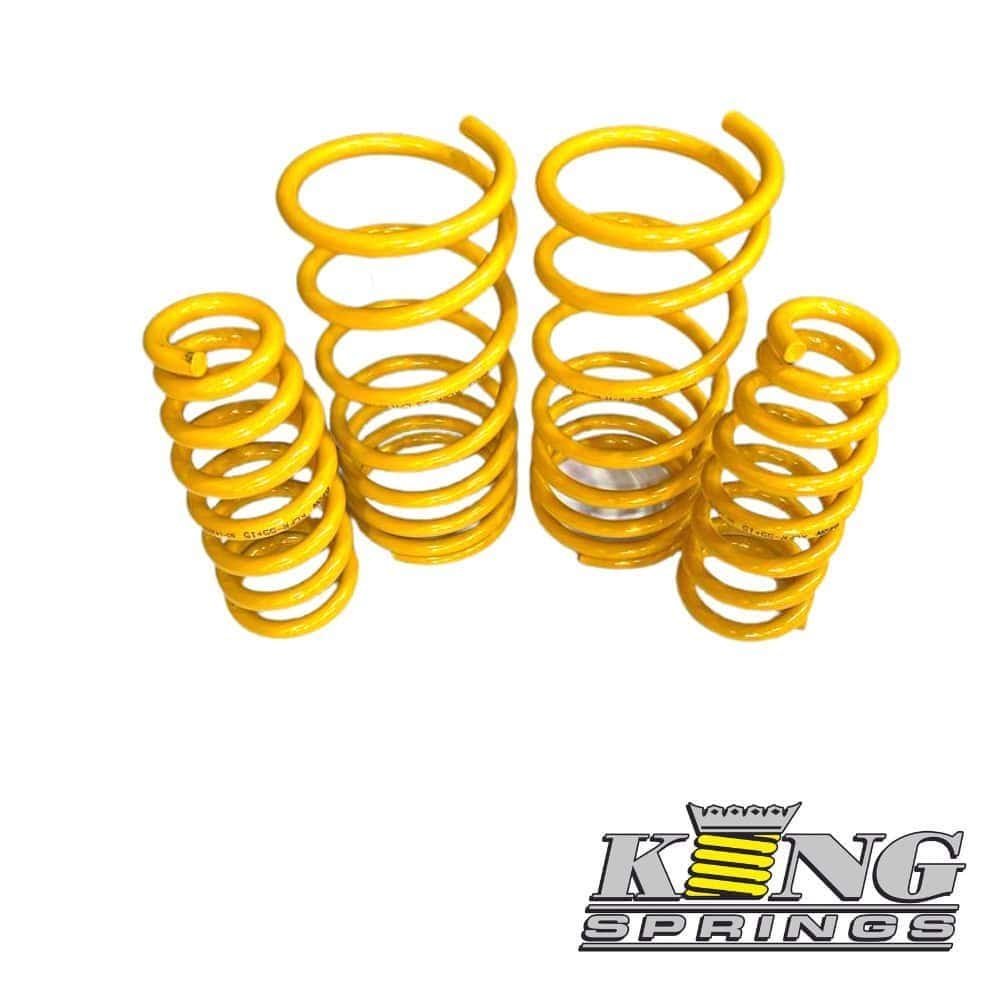 Yellow coil springs for automotive suspension systems, displayed in a group.