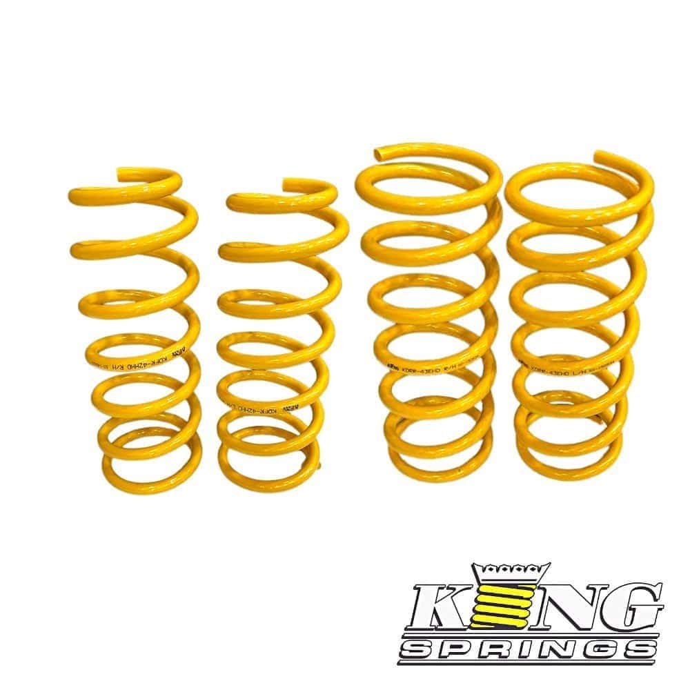 Yellow coil springs for automotive suspension, high-quality and durable.