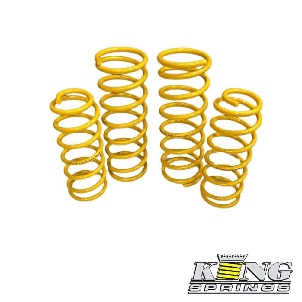 Yellow coil springs for industrial or automotive use, arranged in a group.