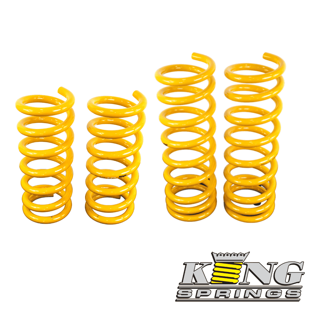 Yellow coil springs for industrial or automotive use, arranged in a row.