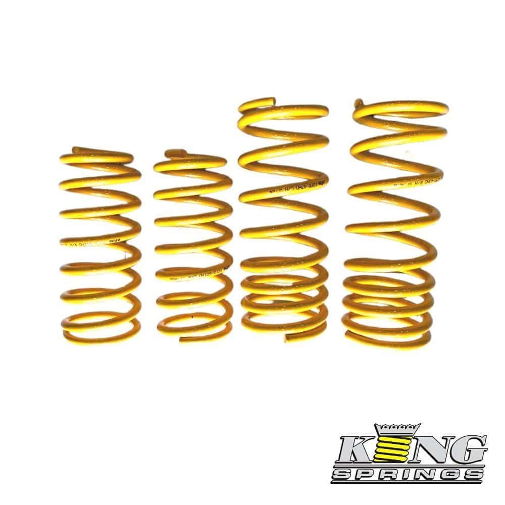 Spring coil suspension springs in gold color, used in automotive shock absorbers.