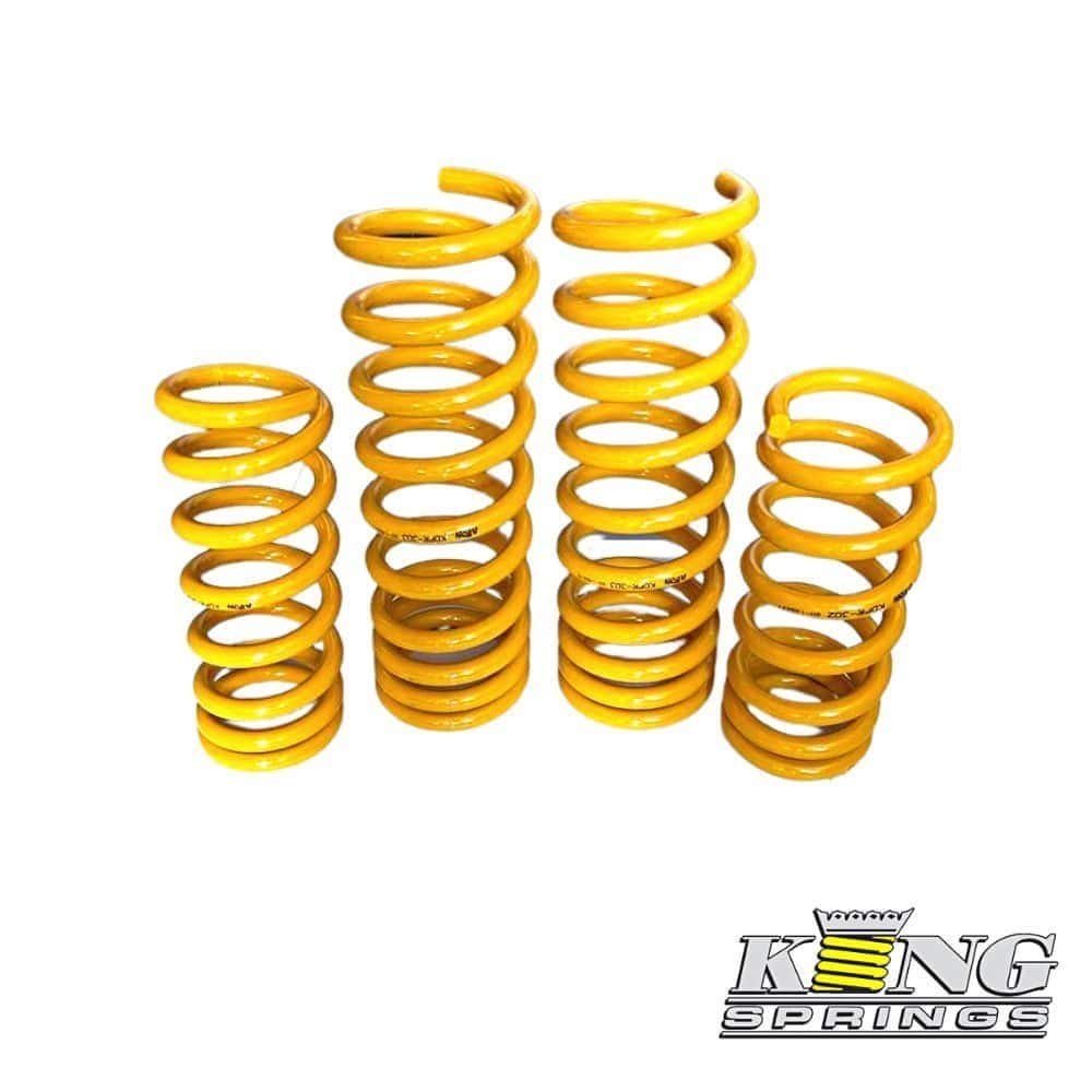 Yellow coil springs for industrial or automotive use, arranged in a row.
