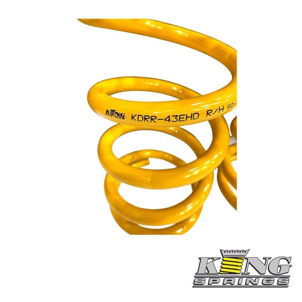 High-performance yellow coil spring for automotive suspension systems.