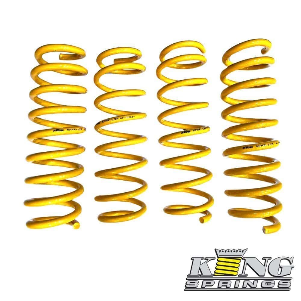 Yellow coil springs for automotive suspension, displayed in a row.
