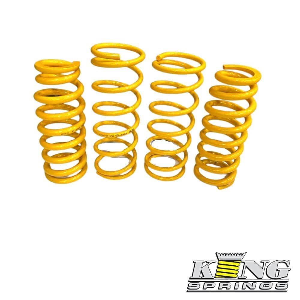 Yellow coil springs for industrial or automotive use, arranged in a row.