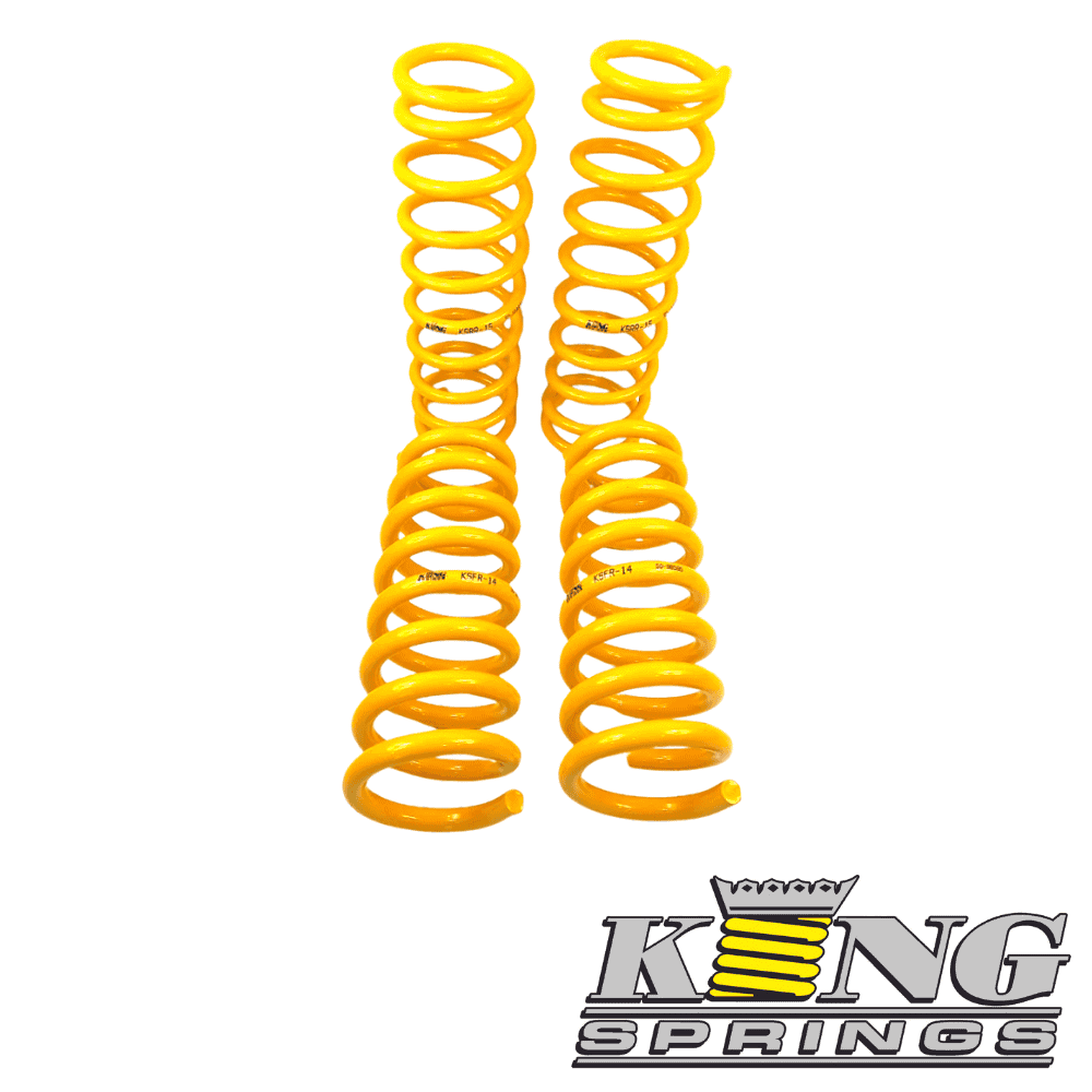 Yellow coil springs for automotive suspension, isolated on white background.