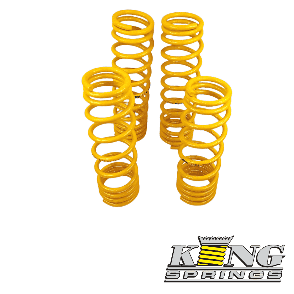 Yellow coil springs for industrial or automotive use, arranged in a group.