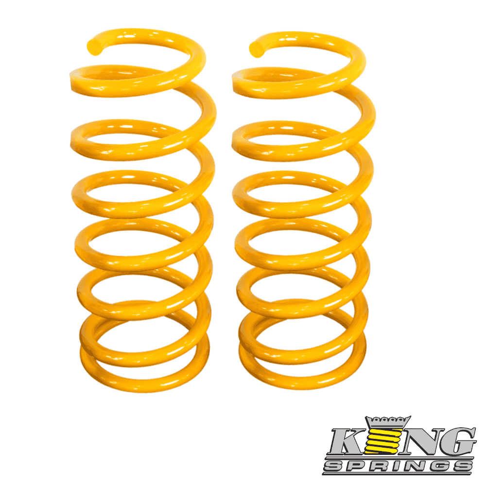 Yellow coil springs for automotive suspension, stacked vertically.