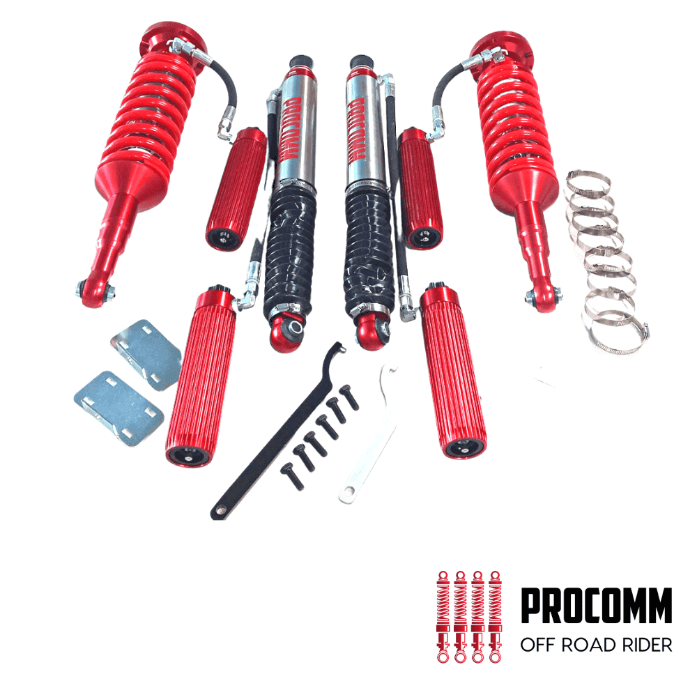 Red motorcycle shock absorbers with tools and mounting hardware for off-road riding.