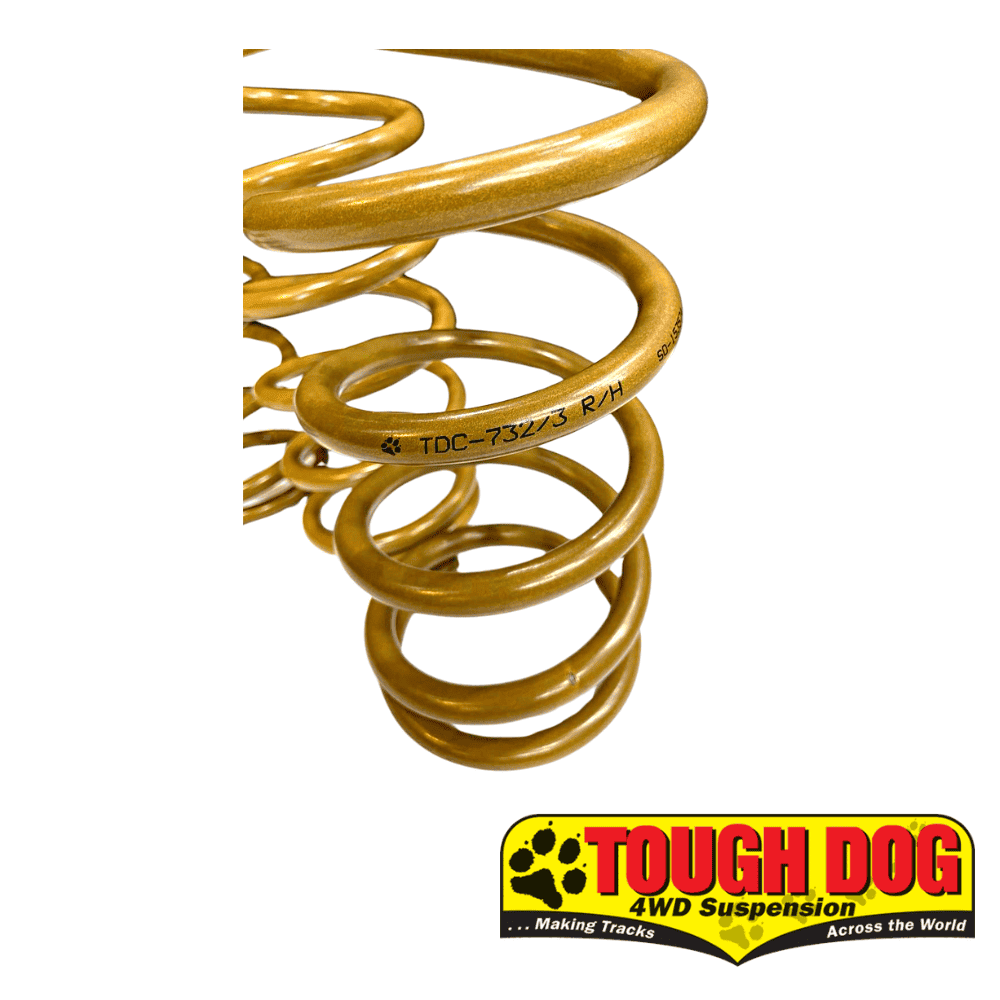 Yellow coil spring for vehicle suspension, close-up view.