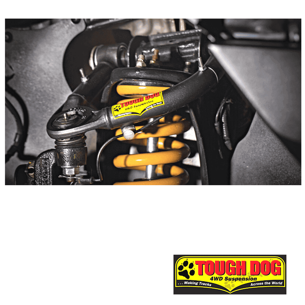 Close-up of a vehicle's suspension system with a Tough Dog shock absorber.