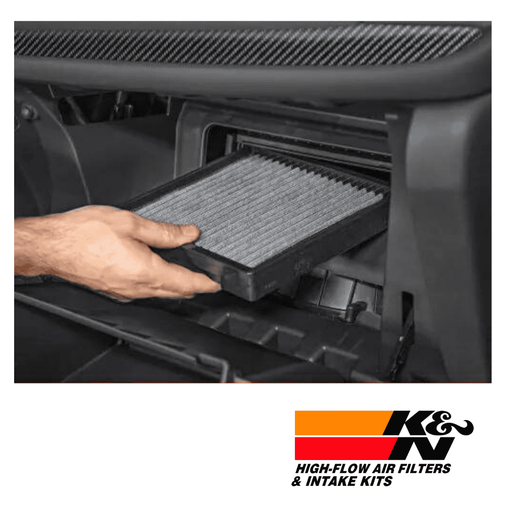 High-flow air filter being installed in vehicle dashboard for optimal engine performance.