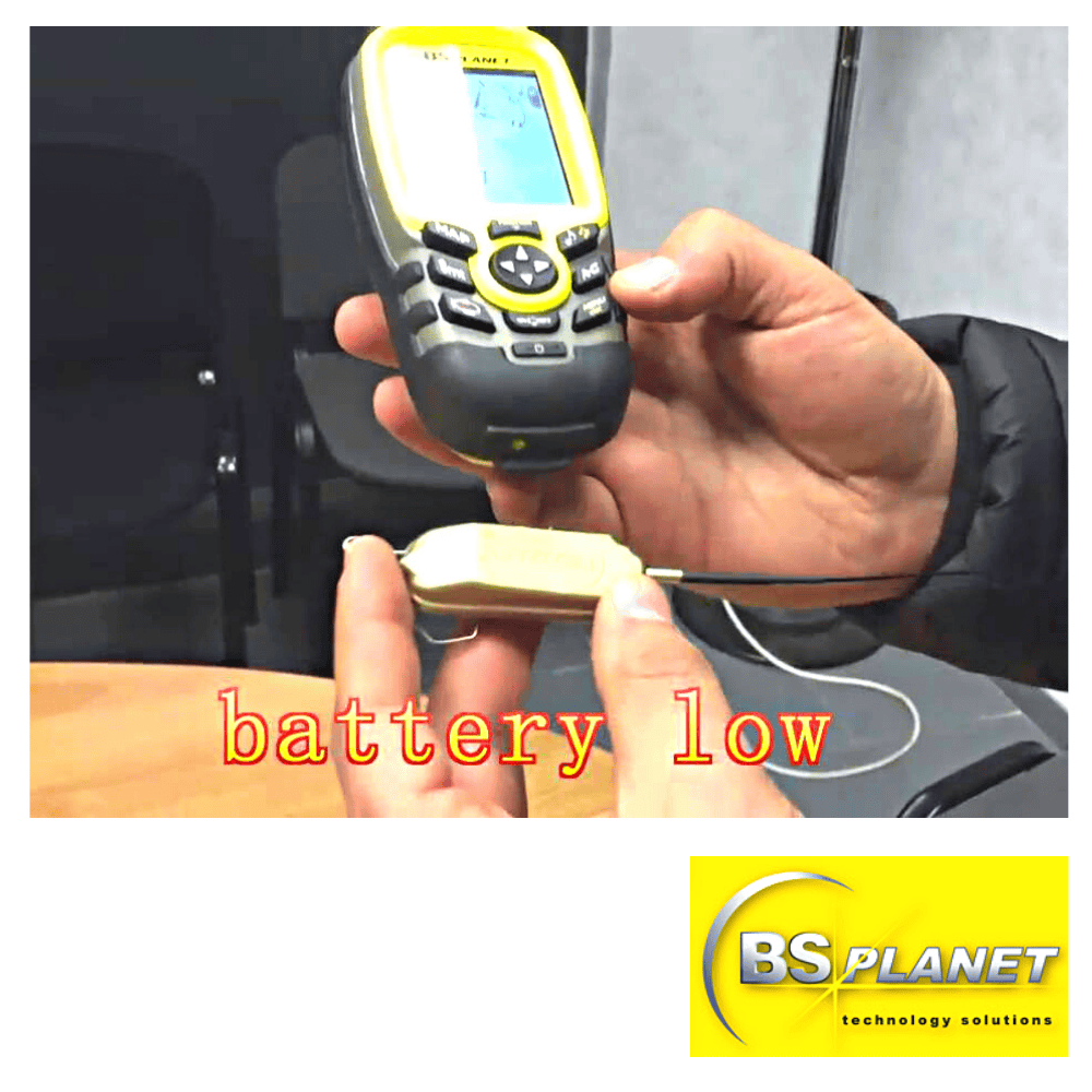 Low battery warning on handheld device with yellow screen and "battery low" text.