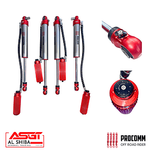 Set of red-and-silver off-road shock absorbers with mounting hardware and a control knob, branded by Procomm and Al Shiba General Trading (ASGT).
