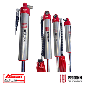 Four Procomm off-road rider shock absorbers with red tops and chrome bodies, displayed with branding logos at the bottom (Al Shiba and Procomm).