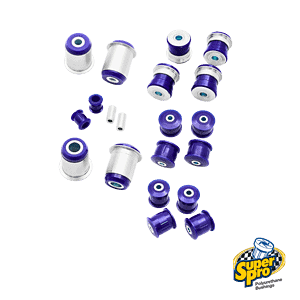 Collection of purple polyurethane bushings and metal sleeves scattered on a black background with the SuperPro logo in the corner, product image for automotive suspension parts.