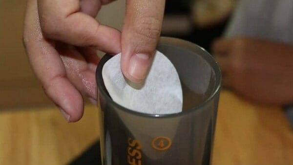 placing aeropress filter to the top of the ground coffee