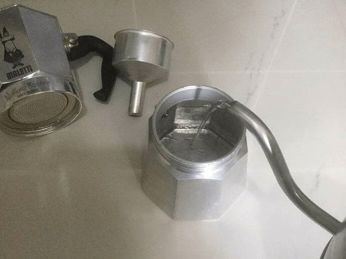 Pouring water into the Moka Pot base section 
