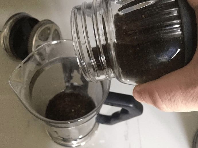 Adding ground coffee to French Press 