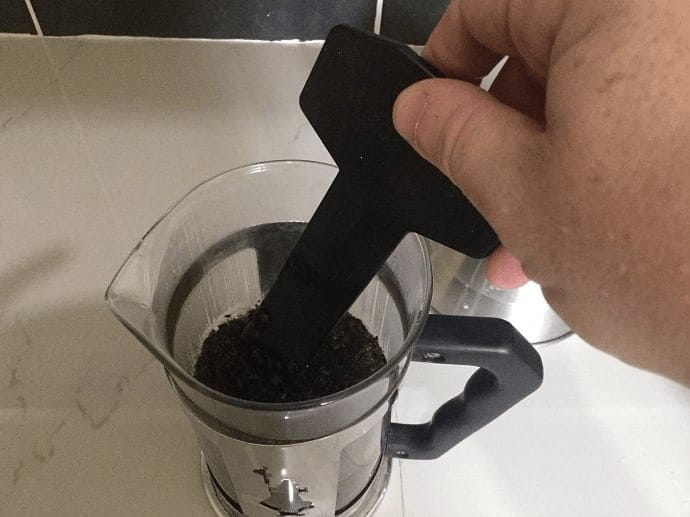 Stirring coffee inside of the French Press 