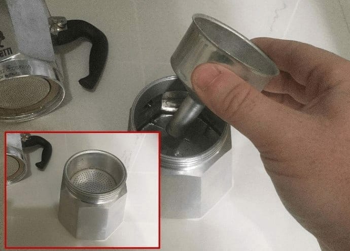 inserting the Moka Pot filter basket 