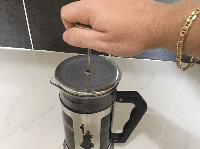 Pressing down on the plunger 