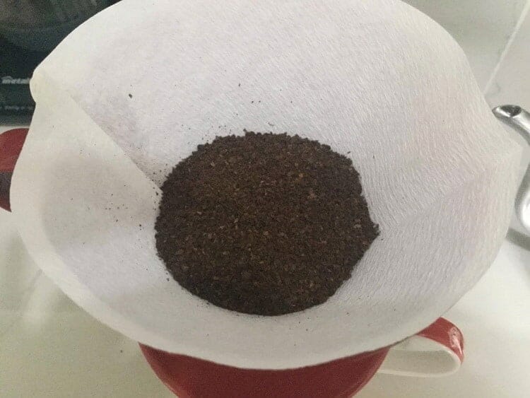Ground coffee added to paper filter 