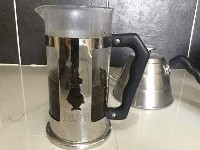 Steeping coffee grounds inside of the French press 