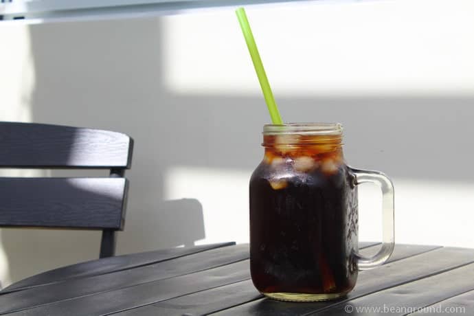 Coffee in a Mason Jar with a green straw