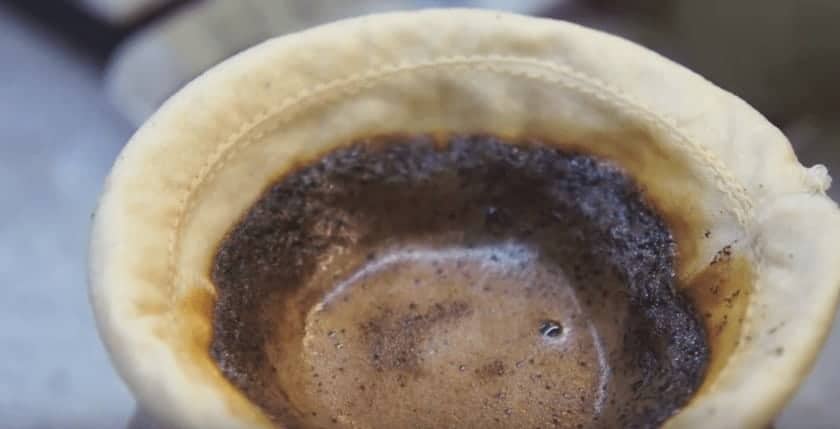 coffee draining through a sock filter 