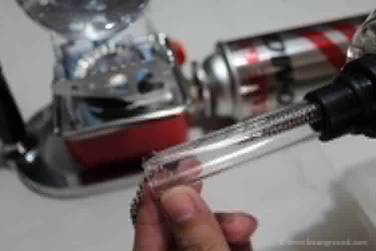 pull the spring wire through-the glass tubing and hook