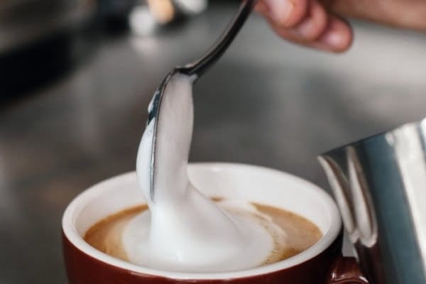 frothed milk collapses on a spoon