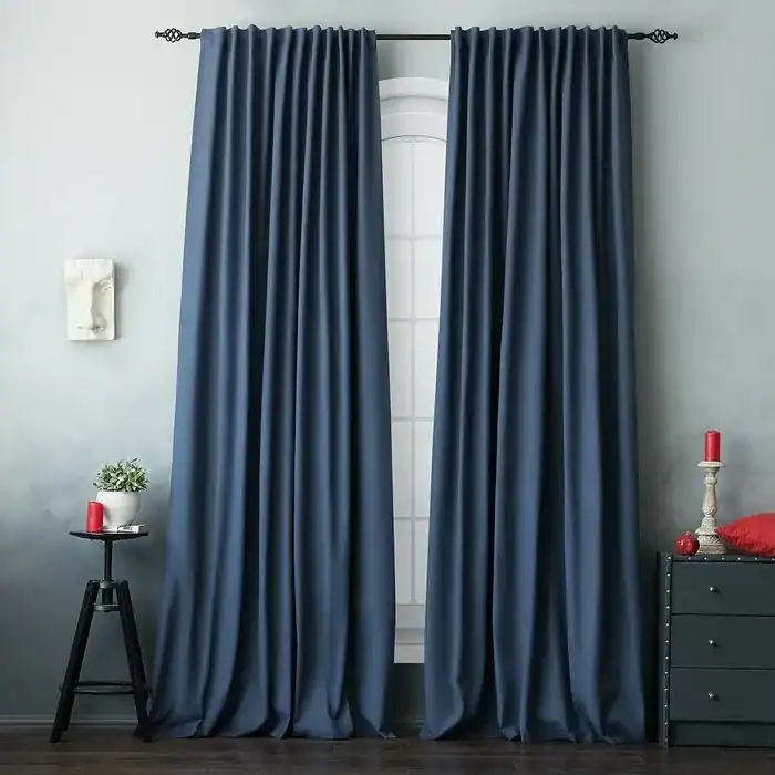 Dark navy blackout curtains hanging in a modern room.