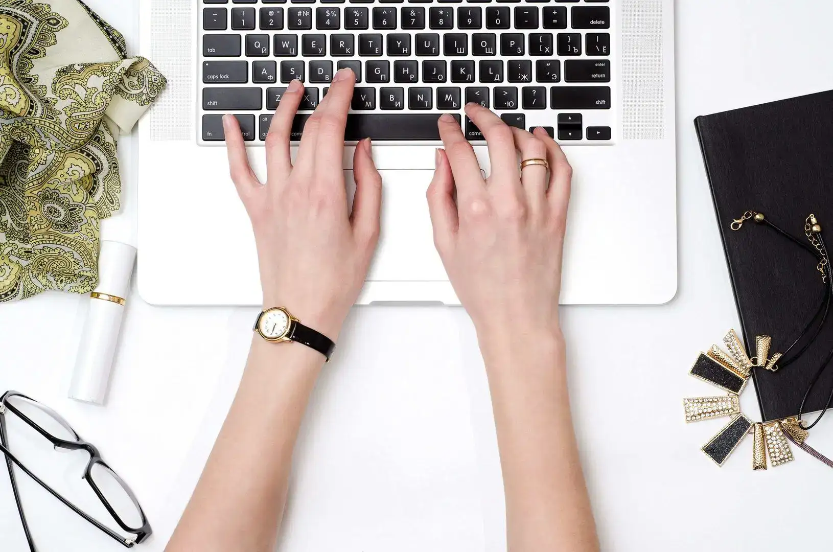 woman’s hands blogging on laptop keyboard