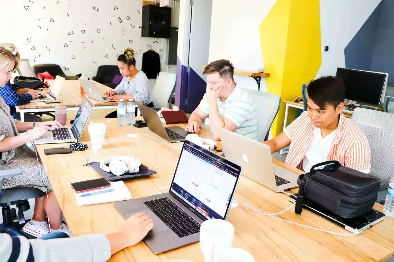 a group of people on laptops optimizing Google My Business listings