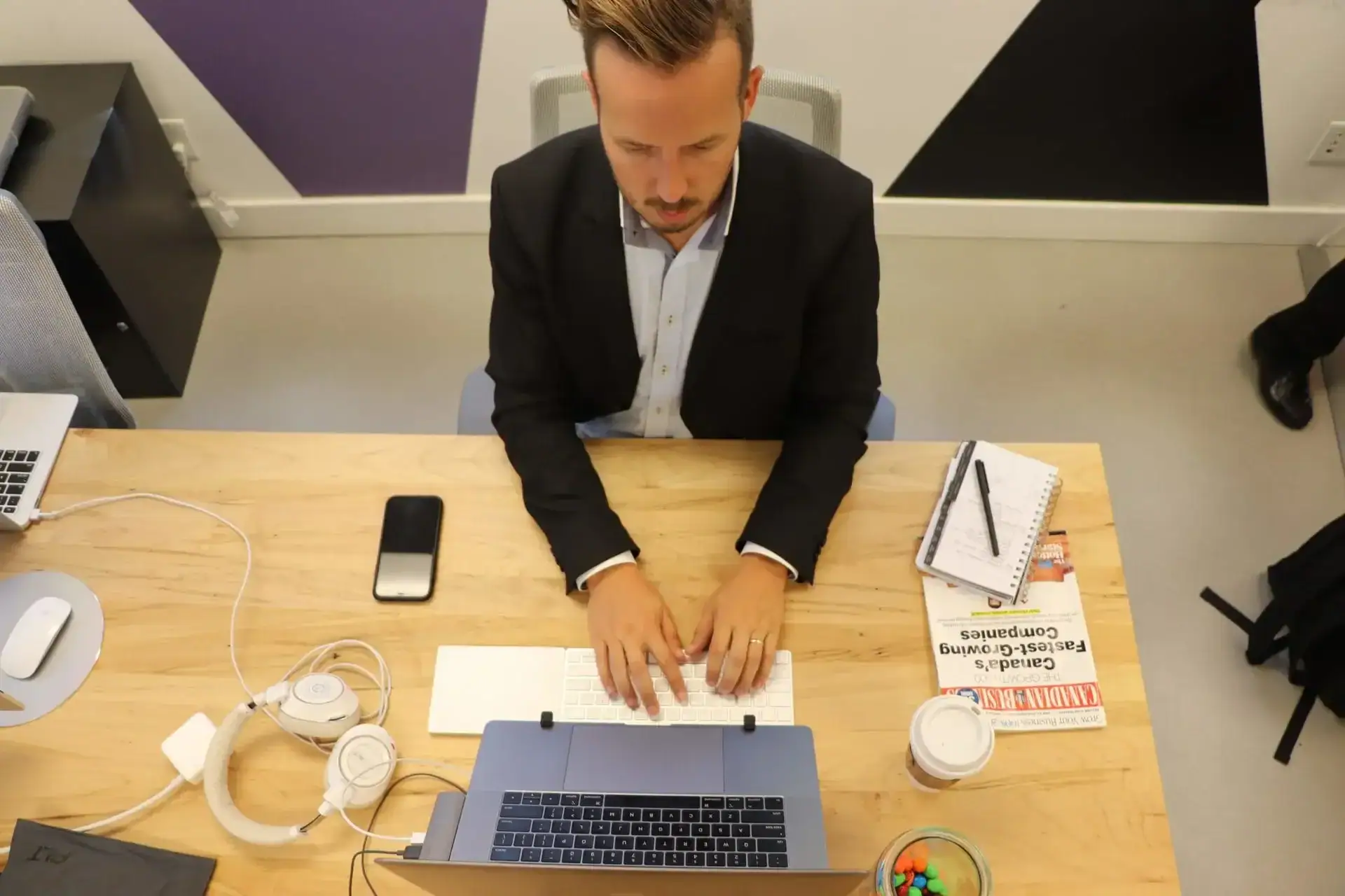 man typing marketing trends on a computer