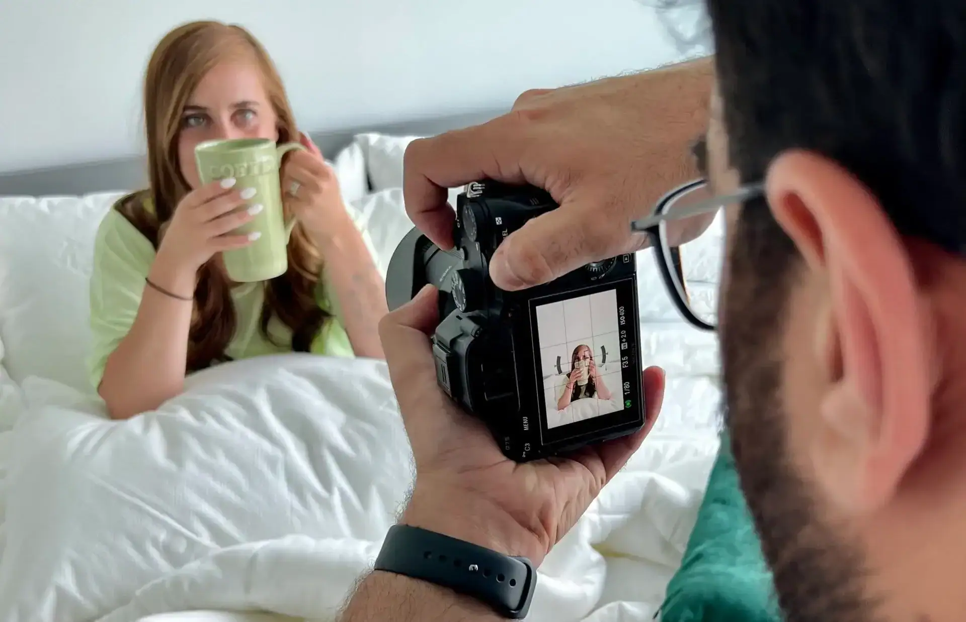image focused on camera taking a picture of girl