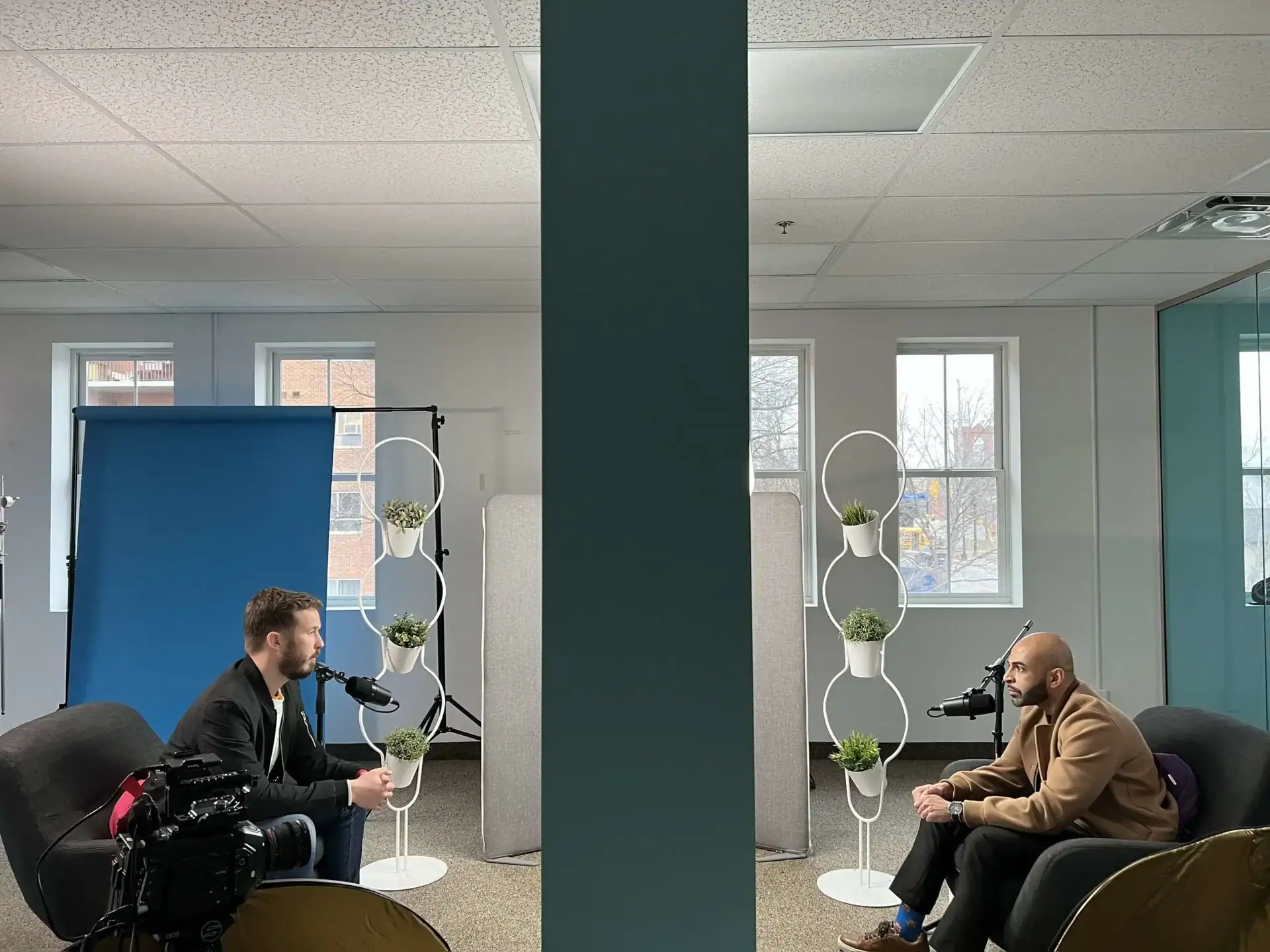 Darrell and Mahfuz looking at each other across the room