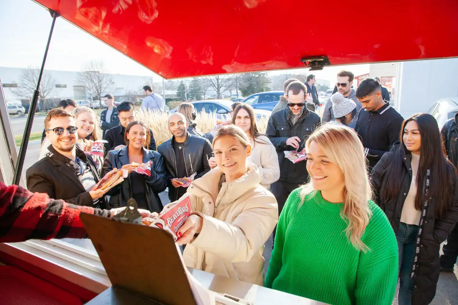 People lining up at a food truck for fresh snacks and meals.