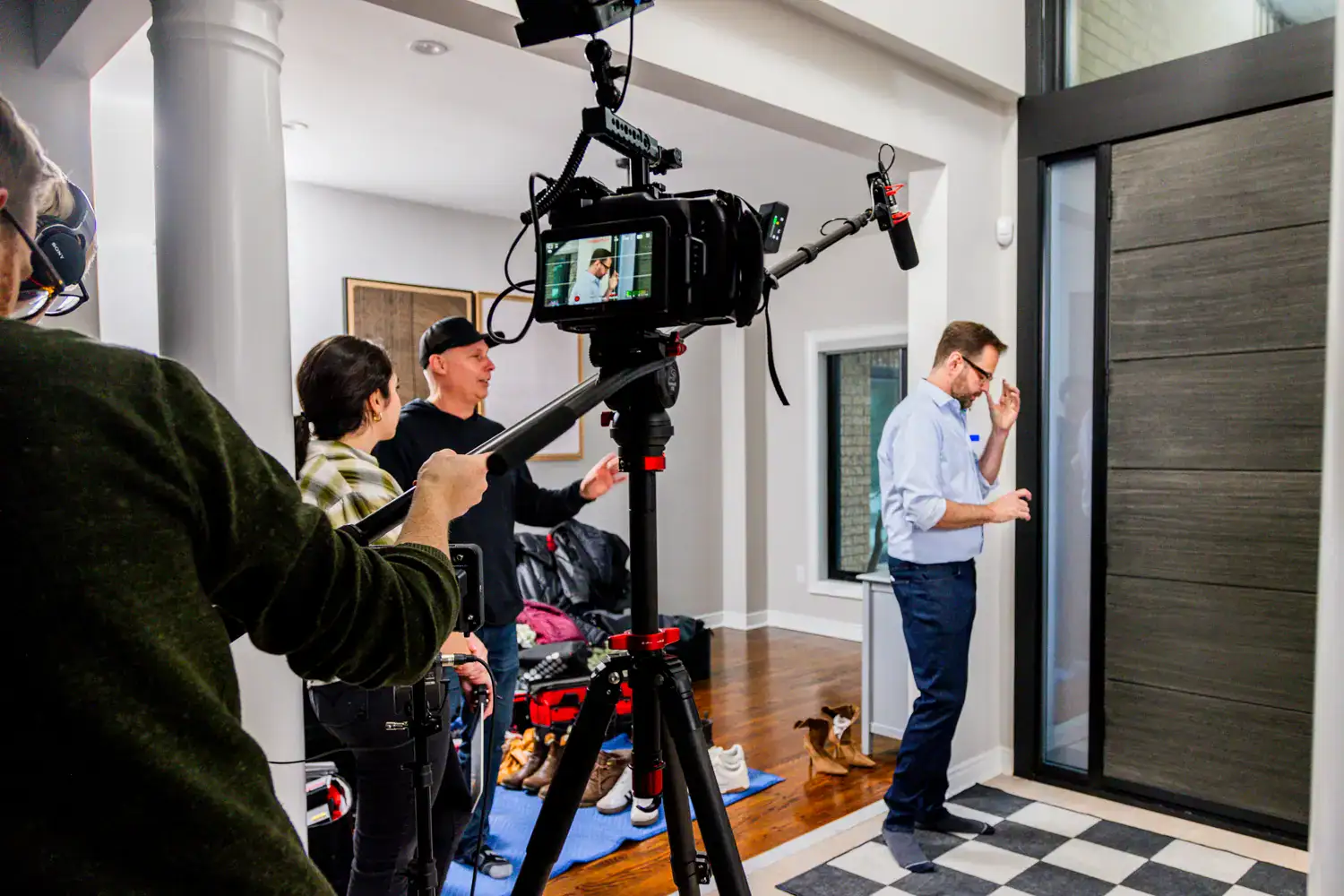 Filmmakers filming a social media video in a modern indoor setting.