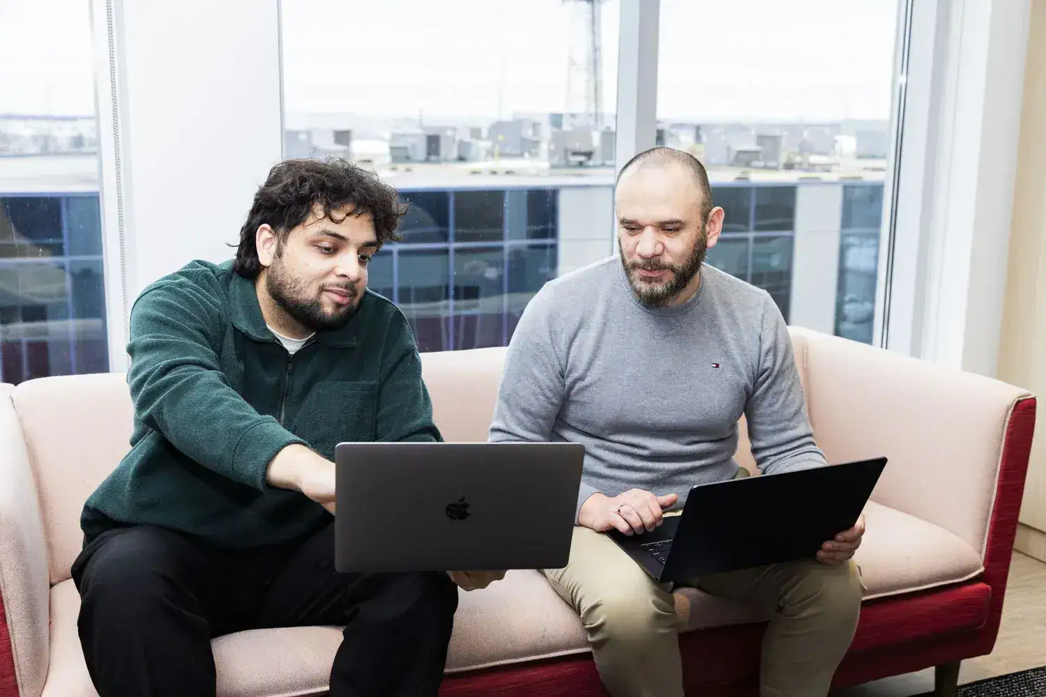 Consulting team using laptops for business services discussion.